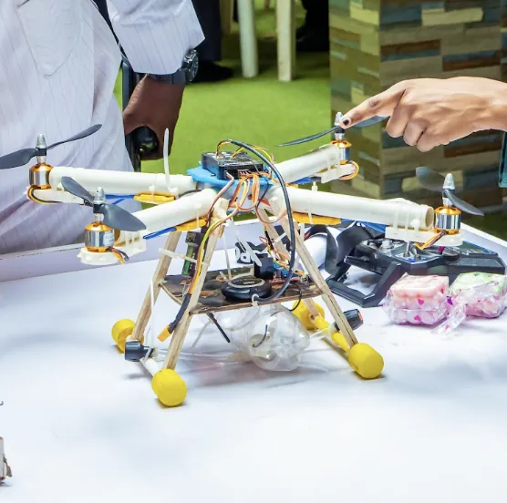 A pupil holding the drone they built