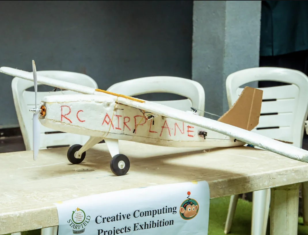Pupils showing the remote-control aeroplanes they built at an exhibition